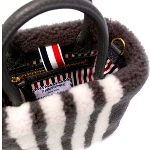 Thom Browne’s Black Small Book Tote in Curly Merino Shearling Bag.